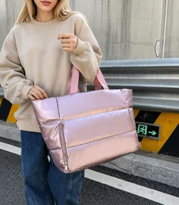 Pink metallic puffer tote bag with quilted nylon texture and side zipper detail
