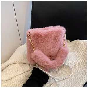 Pink faux fur handbag featuring elegant pearl strap and gold metal chain details