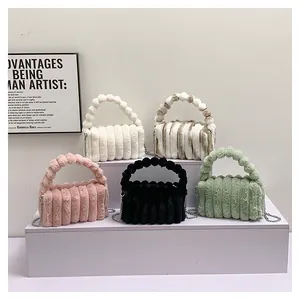 Detailed view of plush handbags with quilted texture and beaded spherical top handles