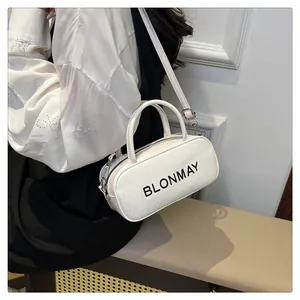 Macro shot of white woven baguette bag with adjustable strap and BLONMAY logo detail
