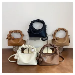 Detailed view of luxury leather handbags in five colors with unique knotted cloud handles