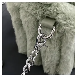 Detailed close-up of mint green faux fur bag with detachable silver metal chain strap