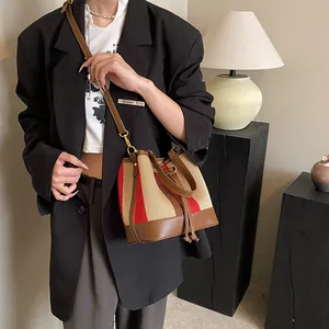 Vintage striped bucket bag in red and brown woven PU leather with adjustable strap