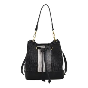Retro striped bucket bag in black and white with woven texture and gold hardware