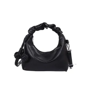 Minimalist black crescent hobo bag with cloud-style ruched handle and texture