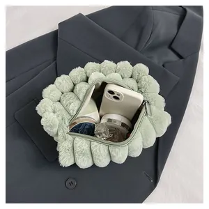 Light green plush handbag with textured bubble pattern and spacious interior compartment