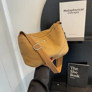 Minimalist canvas crossbody bag in dark camel with adjustable strap and zipper closure