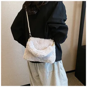 Detailed view of plush faux fur shoulder bag with elegant large pearl chain strap