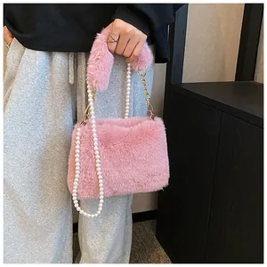 Detail of pink faux fur crossbody bag with plush handle and faux pearl chain strap