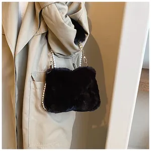 Detail of black faux fur square bag with white faux pearl and gold chain strap hooks