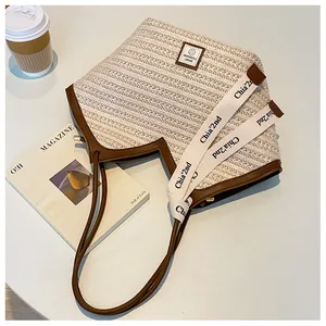 Detailed macro view of woven tote bag texture with brown faux leather trim and sporty logo