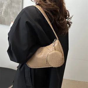 Minimalist khaki crocodile texture shoulder bag with small coin purse worn by model