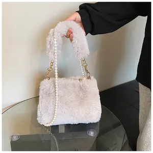 Detail of plush crossbody bag featuring a soft faux fur texture and elegant pearl chain strap