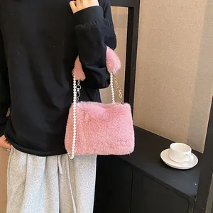 Pink plush crossbody bag with soft faux fur texture and elegant pearl chain strap for women