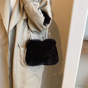 Black plush crossbody bag for women with elegant faux pearl and gold metal chain strap
