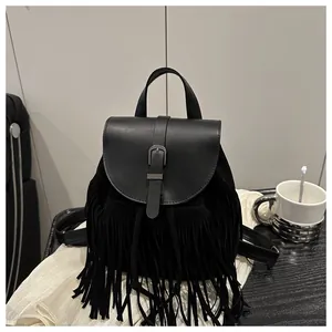 Detail of black leather fringe backpack with metallic buckle and suede patchwork design
