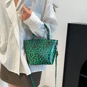 Green leopard print mini tote bag for women featuring glossy finish and crossbody strap