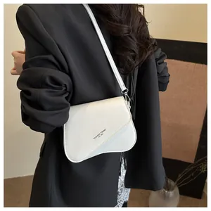 Detail of white square crossbody bag with asymmetric flap and fashion trend lettering