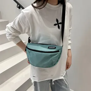 Light blue nylon crossbody bag shown as chest pack on model with white studio background