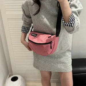 Pink waterproof nylon crossbody chest bag with adjustable strap and fashion label