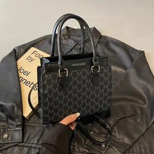 2025 retro fashion tote bag with M-letter print and top handle on leather jacket