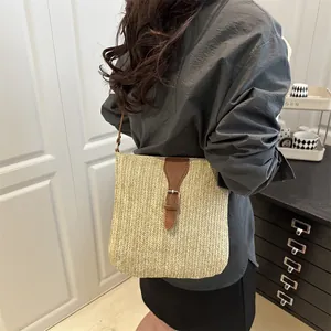 Handcrafted woven straw crossbody bag with brown leather strap for summer beach vacations
