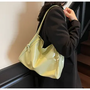 Detail of avocado green patent leather tote bag with stylish side knot and large capacity