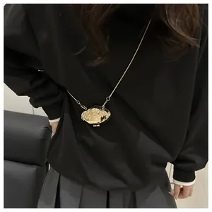 Fashionable golden shell-shaped mini metal crossbody bag with stylish chain strap for women