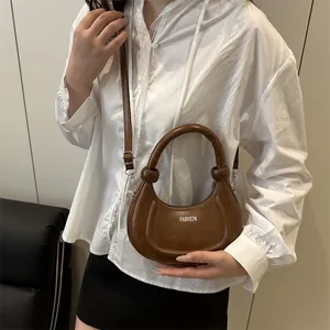 Chic brown crescent leather shoulder bag with FASHION text for women 2025 summer