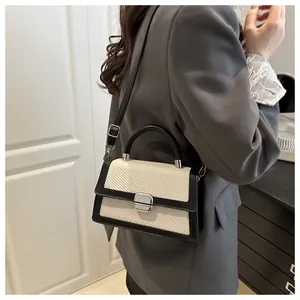 Model view of bicolor crossbody bag with woven flap and black leather details