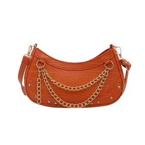 Bright orange crocodile pattern crescent shoulder bag with golden chain and studs