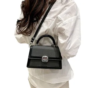 Modern black minimalist crossbody bag with woven texture and silver buckle for women