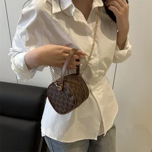 Brown monogram cylindrical mini bag with golden chain strap for stylish women