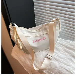 Detail of white nylon hobo bag with pink fashion lettering and rope knot zipper pull