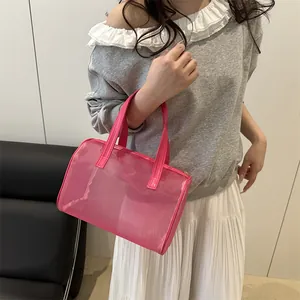 Pink semi-transparent mesh handbag with leather handles and top zipper closure