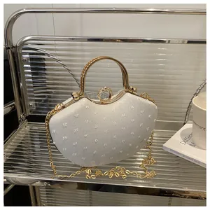 Detail of evening clutch featuring embossed fabric texture and sparkling rhinestone buckle