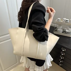 Large cream-white tote bag with FASHION logo in modern minimalist interior setting