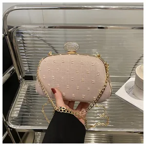Close-up of evening clutch bag with textured fabric and large rhinestone clasp