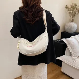 White minimalist canvas hobo bag with pink fashion lettering and wide fabric shoulder strap
