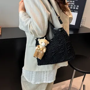 Elegant black bubble texture bucket bag with cute bear pendant and adjustable strap