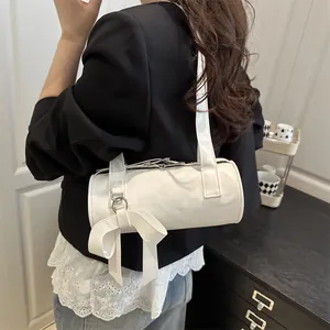 White cylinder underarm bag with bow decoration and stylish PU leather texture
