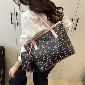 Women's black tote bag with pink bow print and small purse set for daily commute