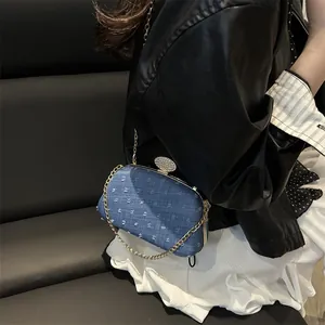 Blue denim chain crossbody bag with polka dot texture and rhinestone top closure