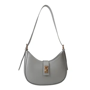 Minimalist grey crescent underarm bag with gold metal buckle and leather strap