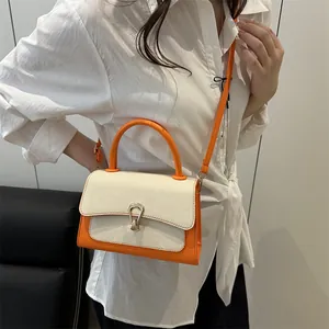 Chic orange and cream woven crossbody bag with golden buckle and circular top handle