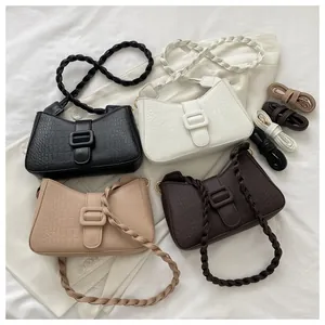 Detail view of crocodile pattern hobo bags in four colors with woven handles
