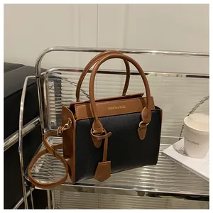 Detail view of contrast color crossbody bag with lychee texture on chrome shelf