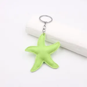 Vibrant lime green leather starfish keychain charm with intricate white stitching for bags
