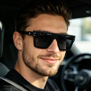 Close-up of black oversized polarized sunglasses with silver metal rivets on a man driving