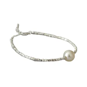 Irregular shimmering silver beads and pearl bracelet with extension chain on white background